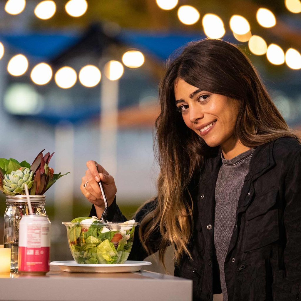 Image of Woman Eating on FIGat7th outdoor Plaza Level