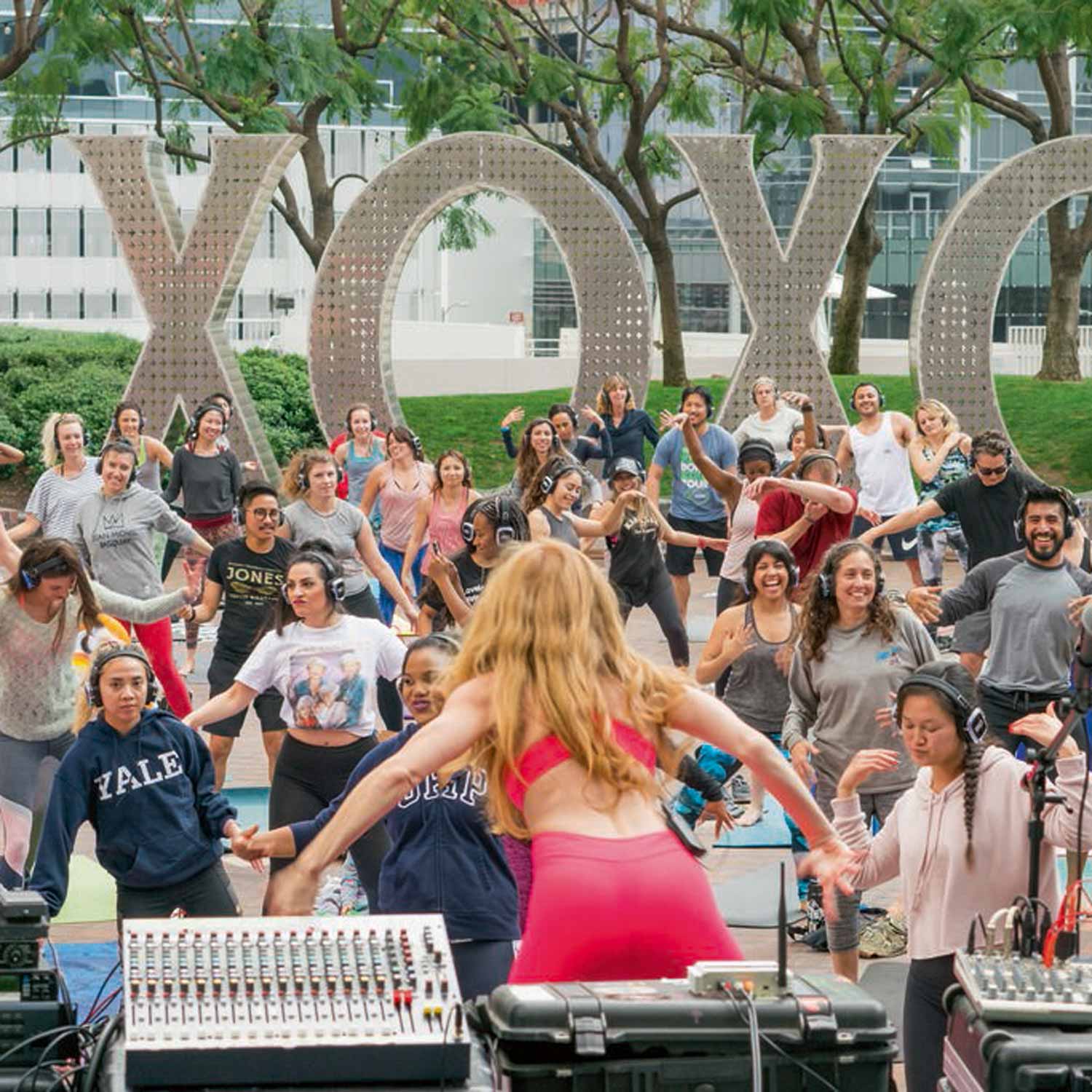 Image of Yoga Class in Front of Art Installation of Monumental Words