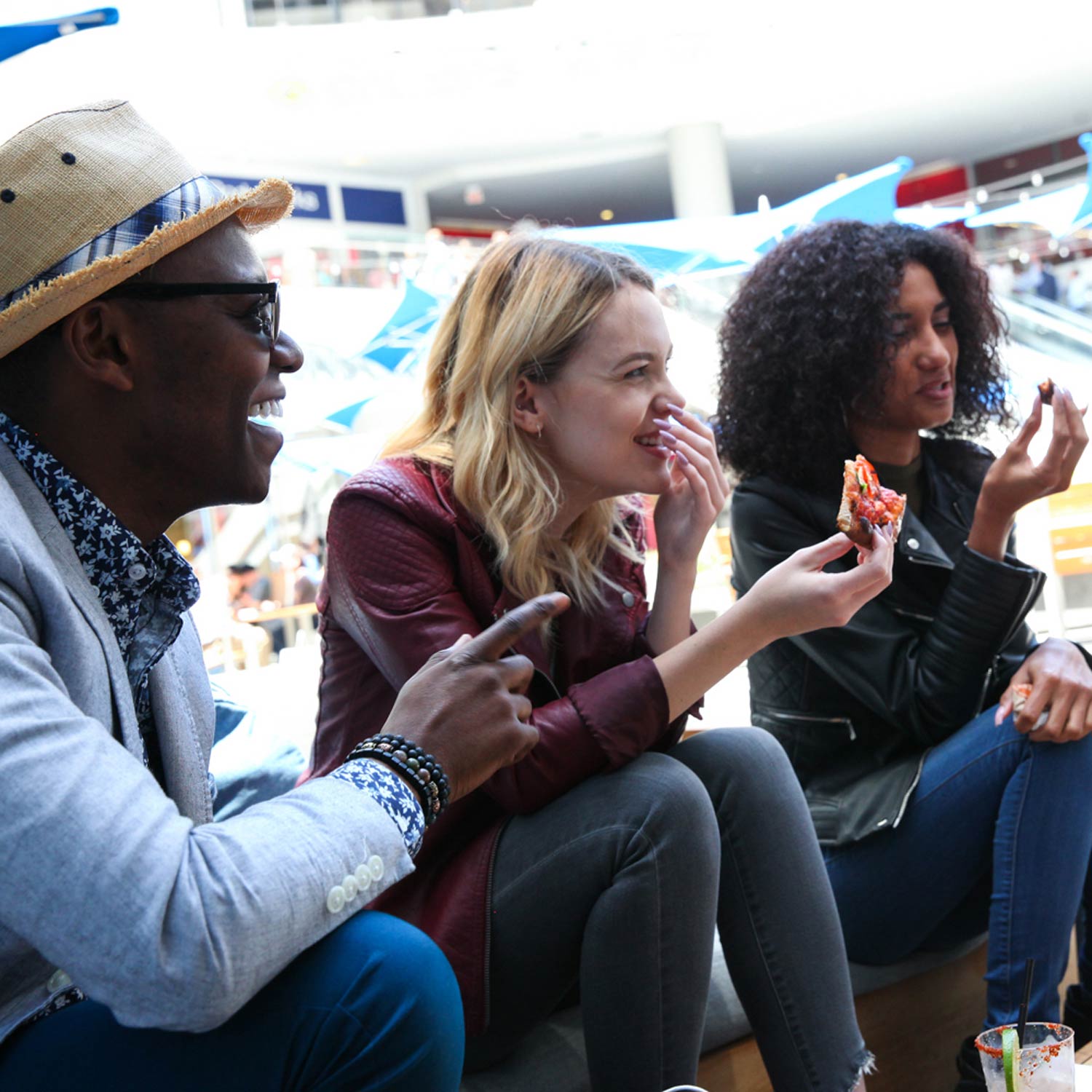 Image of One Man and Two Women Eating Happily